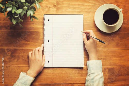 Fotografie, Tablou Hands of a person writing in a small notepad
