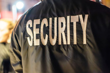 The Word "security" On The Back Of A Security Guard's Jacket.