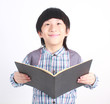Portrait of young happy boy with book