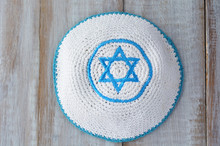 Flat Lay Of A Knitted Kippah With Embroidered Blue And White Sta
