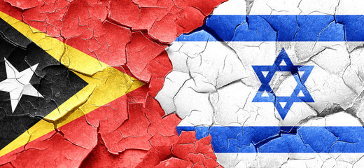 east timor flag with Israel flag on a grunge cracked wall