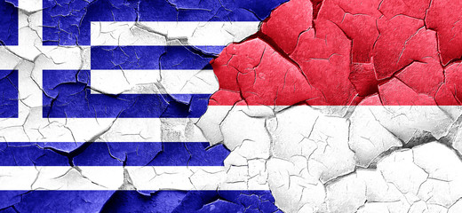 Greece flag with Indonesia flag on a grunge cracked wall