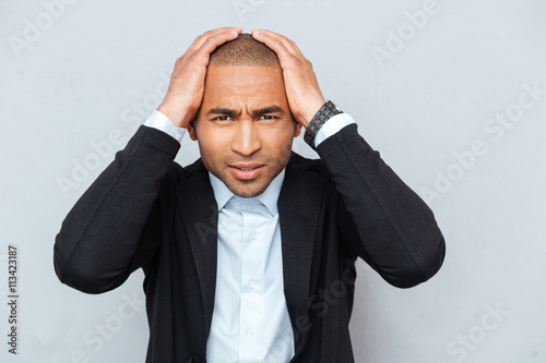 Fotografie, Obraz Closeup portrait of unhappy upset guy isolated on gray background