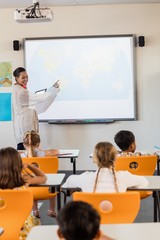 teacher giving lesson to her students
