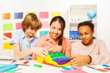 Wall Mural - Students modeling surface relief with plasticine