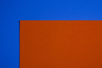 Eva foam ethylene vinyl acetate sponge plush orange surface on blue smooth background