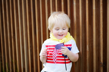 Wall Mural - Cute toddler boy holding american flag