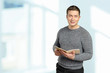 © fotofabrika - Handsome young man holding book