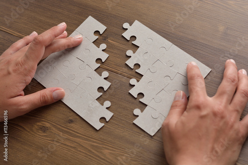 Fotografie, Tablou Folding puzzle hand parts on a wooden table