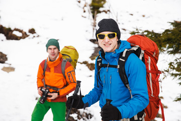 Wall Mural - Two hikers in winter mountains