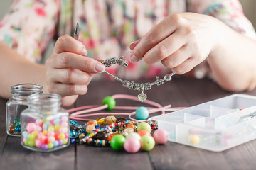 Woman make homemade bracelet