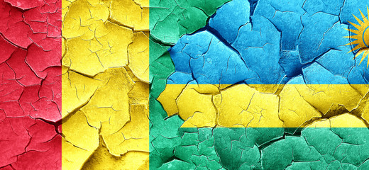 Guinea flag with rwanda flag on a grunge cracked wall