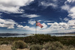 © Cavan Images - American flag waving against a cloudy sky