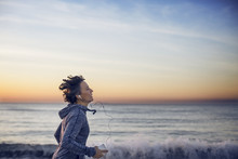 Woman Jogging At Beach Against Sky