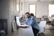 © Cavan Images - Man working on laptop in office