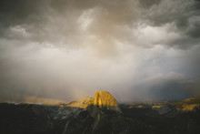 Scenic View Of Rocky Mountains Against Cloudy Sky