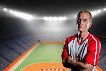 Poster - Portrait of volleyball player with arms crossed against handball field indoor 