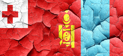 Tonga flag with Mongolia flag on a grunge cracked wall