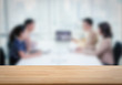 © phonlamaiphoto - wooden table with business consult background