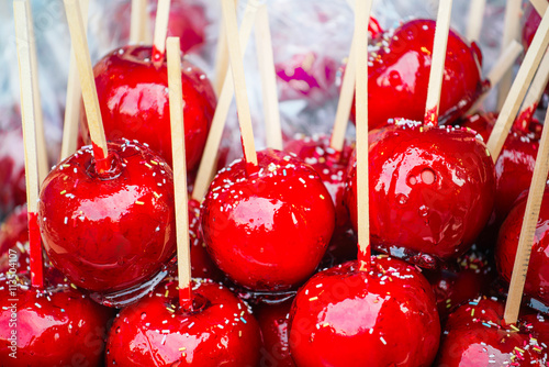 Plakat Sweet glazed red toffee candy apples on sticks