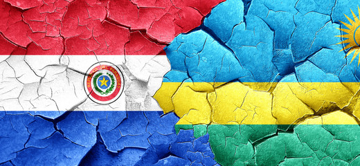 Paraguay flag with rwanda flag on a grunge cracked wall