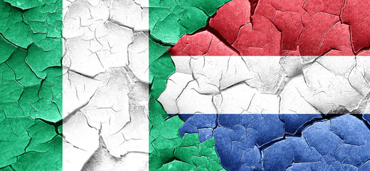 Nigeria flag with Netherlands flag on a grunge cracked wall