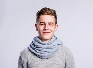 Poster - Boy in gray sweater and scarf, young man, studio shot