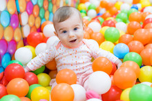 Beautiful Baby Girl Playing With Colorful Balls