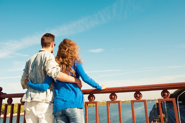 Sticker -  Back view of man and woman huging together on the bridge