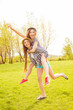 © deagreez - Happy  young woman piggybacking her cheerful sister in the park