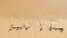 The Word Love On Sand Beach