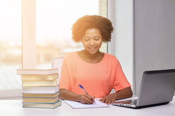 Canvas Print - happy african american woman with laptop at home