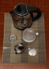 Morning coffee served in vietnam coffee filter on rattan table with two rattan chairs