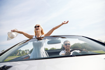 Poster - happy man and woman driving in cabriolet car