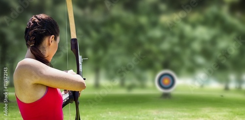 Fotografía Image of rear view of sportswoman doing archery