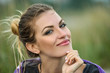 Outdoor portrait of beautiful smiling woman with bright  professional make-up.