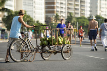 Street Vendor Delivering Green Coconuts From A Cart On The Beachfront Street In Copacabana Beach