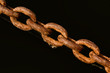An old rusty chain on a black background