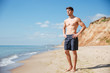 © Drobot Dean - Relaxed young man standing on the beach