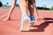 © WavebreakMediaMicro - Female athlete ready to run on running track
