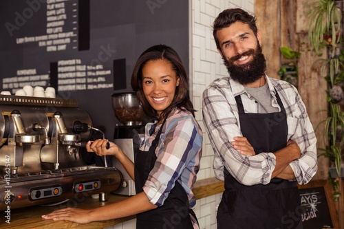 Fotografía Portrait of two waiters with a coffee machine