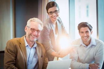Aufkleber - Portrait of business people discussing over digital tablet