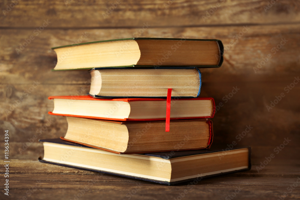 Pile of books on wooden background