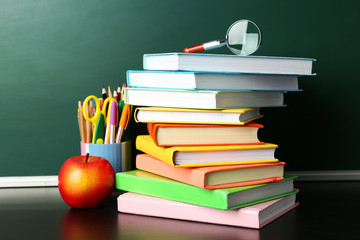 Poster - School books on desk near chalkboard