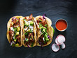 canvas print picture - three mexican pork carnitas tacos flat lay composition