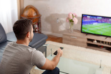 Man Watching Soccer In Living Room