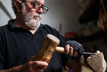 Senior Sculptor Working On His Sculpture In His Workshop.