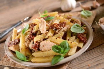 Wall Mural - Penne pasta with chicken, dried tomatoes and ruckola