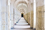 Fototapeta Na drzwi - Castle tunnel with a series of arches in the ruined Bastion fortress in the Slovak city of Komarno.