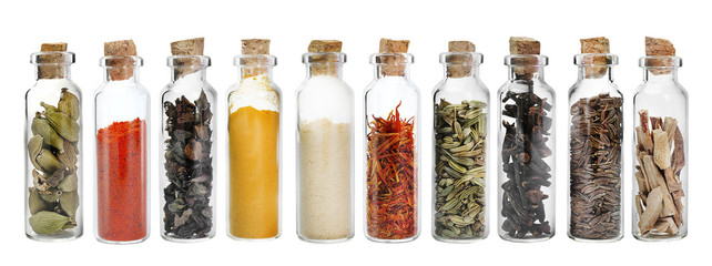 Wall Mural - Set of different spices in glass jars. Isolated on white